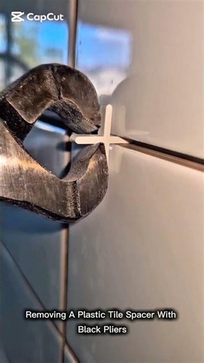 Removing A Plastic Tile Spacer With Black Pliers