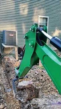 John Deere Backhoe Digging a Ditch for Downspout Drainage