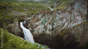 One of the beautiful waterfalls in the Hardangervidda national park, Norway. The powerful torrent of raging water falling from the high jagged cliffs.