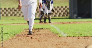 Low section of female baseball players playing on the field, hitter running for base