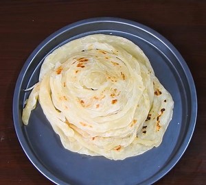 Easy Soft Layered Parotta 🥞 | Flaky Kerala Parotta | Street Style Multi Layer Paratha at Home Make this delicious Easy Soft Layered Parotta at home and enjoy restaurant-style flaky layers! This soft Layered Parotta is so easy to make, no special skills needed. Perfect for pairing with any spicy curry or kurma. Once you try this street style Layered Parotta, you’ll never want store-bought again! Hot, soft & flaky every time. Try this viral method — twist, coil & roll for perfect layers. Save, sh