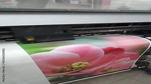 Large format printing machine in operation. Industry. Printing production. Printing on large format printer. printer prints photo. Modern print equipment. Colored print