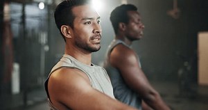 Men at gym together, stretching arms and muscle building strong body, balance and power in fitness. Commitment, motivation and class, flexible bodybuilder in workout challenge with personal trainer.