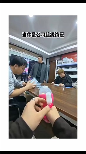 Obscura on Instagram: "This instagram video depicts a Chinese pharmacy team meeting where the boss calmly dispenses a sanitary napkin from a pink feminine hygiene dispenser, oblivious to its purpose, while colleagues struggle to contain their laughter, turning an awkward mishap into a viral comedy clip.Shared by XTrollVideo , an account curating humorous troll content, the post exploded to 31,000 likes and 6.4 million views in under 12 hours, underscoring the universal appeal of relatable workpl