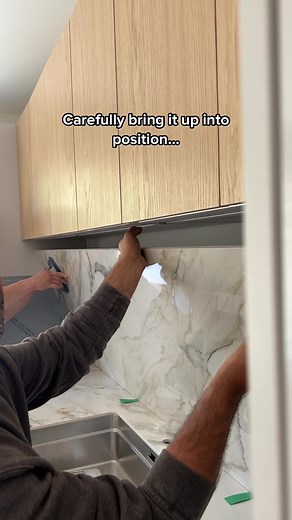 How we install splashbacks on a job. We love the way full height splashbacks look in a kitchen design, especially when your stone has incredible veining as shown here. #kitchendesign #worktops #fabrication #installation #stonework #porcelain