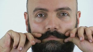 Man combing his mustache - Free Stock Video