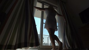 Woman opening the curtains - Free Stock Video