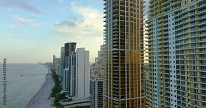 High angle view of Sunny Isles Beach city with beachfront high-rise hotels and condo buildings on Atlantic ocean shore. American tourism infrastructure in coastal southern Florida