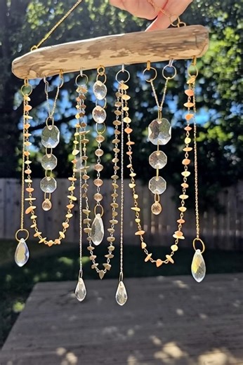 Bring some sparkle to your porch with this DIY suncatcher! ✨ Start with a weathered piece of driftwood as your base. Drill small pilot holes and screw in tiny eye hooks to hang your chains. #DIY | DIY Crafts and Projects