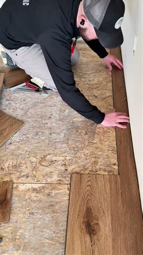 installing wood grain patterned laminate flooring panels over an oriented strand board subfloor
