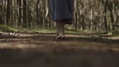 female barefoot legs walking on wooden footpath in summer forest pine...