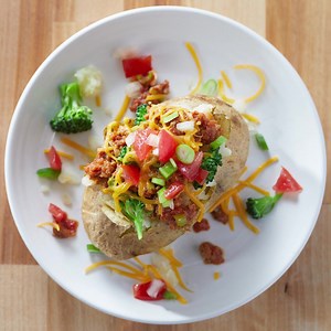 Take it back to the classics with a loaded baked potato. Find the recipe here: https://www.morningstarfarms.com/en_US/recipes/loaded-baked-potatoes-recipe.html | MorningStar Farms