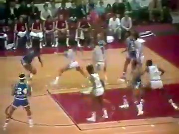 April 20, 1975: Lots going on in this clip of Sam Lacey scoring for Kansas City-Omaha in Game 5 of the Western Conference Semis in Chicago.—Very visible hockey boards/glass—Jerry Sloan and Rick Adelman in uniform—Shot clock on the floor—Jerry West calling the game for CBS