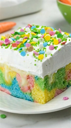 Dreamy Pastel Easter Poke Cake with White Chocolate Clouds This Easter Poke Cake is pure springtime joy in every slice — soft, pastel-swirled cake soaked with silky white chocolate pudding and topped with fluffy, homemade whipped cream. It’s bright, creamy, and melt-in-your-mouth tender with ribbons of color in every bite. Perfect for your spring brunch table or holiday dessert spread, this beauty is guaranteed to steal the spotlight. Save this recipe and tag the friend who loves a show-stopping