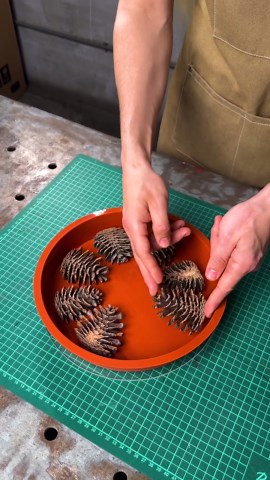 DIY epoxy resin cutting board with stunning pine cone design