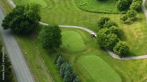 Bird's eye view of golfer ready to swing, panning aerial shot in golf course