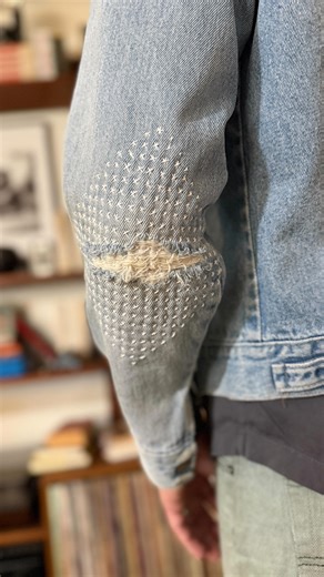 Lauren Gonzalez-Johnson on Instagram: "Took my mending project to-go and spent a lovely Sunday afternoon with my partner sitting outside, talking, reading, mending and enjoying some time outside. Embroidery and mending is absolutely an on the go activity and I especially love being able to get out and stitch in public. It’s national mending in public day every day if it were up to me! I used our Star/Cross stick ‘n stitch pattern and “make it a kit” thread, needle, scissors add on for this quick