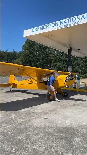 Hand propping a 1939 Piper Cub.