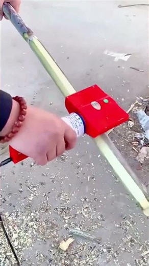 Close-Up Depicts Bamboo Peeling Process With Machine