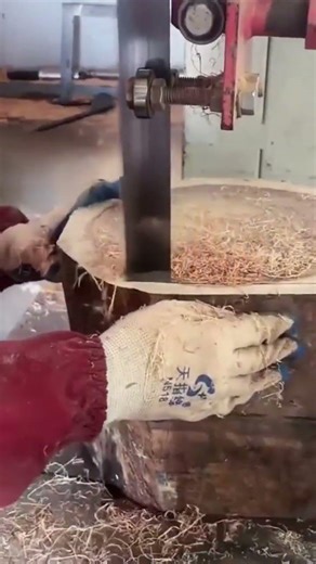 Cutting a large wooden log using a professional band saw machine for woodworking projects