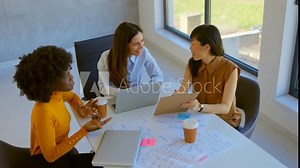 4k video footage of a group of young businesspeople using a laptop together in a modern office. Small Business. New Business. Business professionals contributing their ideas in a collaboration.