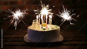cake birthday party in a dark room with lots of candles and sparklers