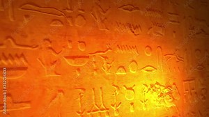 Ancient Egyptian lettering or language inside tomb of the pyramids lit by candle V2 Stock Video