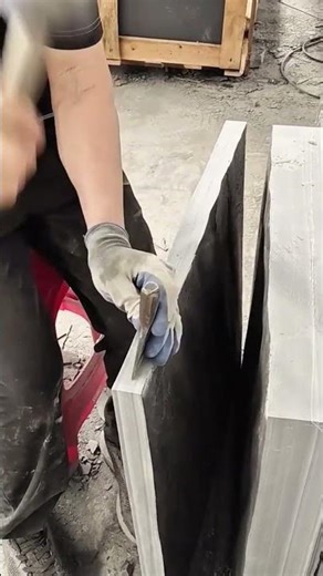 Splitting large stone slabs precisely using a metal chisel and hammer to create thin layers