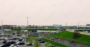 Top view of cars traffic on road and crowded parking. Wide view of navigating interchange road system with traffic at busy work day. Concept using personal timetable to avoid traffic on road afternoon