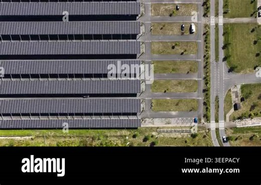Modern solar canopy car park seen from above, combining photovoltaic roofs and shaded parking to deliver renewable electricity and sustainable urban infrastructure for vehicles Stock Video Footage - Alamy