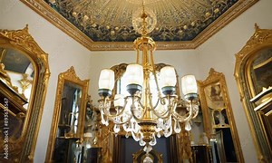 Capture the opulence of a classic French chateau interior, with ornate furnishings, intricate moldings, and rich fabrics exuding timeless elegance for 4K hyperrealistic video.