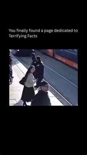 Terrifying As Facts on Instagram: "At a busy tram stop in Turkey, one distracted step onto steel rails nearly ended a life before anyone could scream in broad daylight seconds. Headphones sealed her off from reality as a tram thundered closer, bells unheard. A security guard spotted the danger, sprinted forward, seized her arm, and dragged her back. Seconds later, the vehicle tore past, where her body would have been, turning routine surveillance into a moment between existence and erasure. Capt