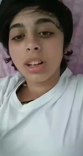 Individual in White Shirt Against Blurred Interior Background