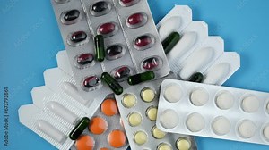 Medications for treatment of acute and chronic bacterial prostatitis, prostate adenoma, frequent urination and erectile dysfunction. Tablets, pills and rectal suppositories on blue background.