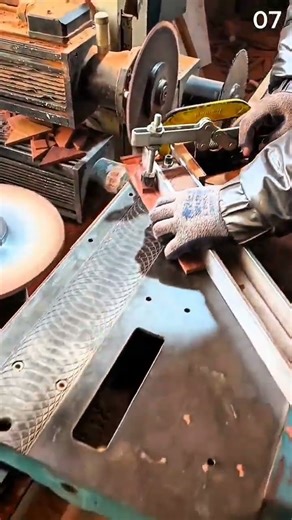 Grinding rectangular metal piece with abrasive wheel tool