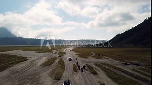 4K Tracking by drone on driving experience to Mt.Bromo, Pasuruan, East Java, Indonesia. Adventure driving Off-road Jeep 4WD into Beautiful active Volcano with smoke Mount Bromo. Stock Video
