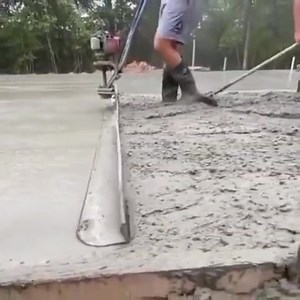 Smoothing concrete with a vibrating concrete power screed float...