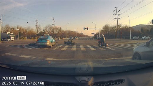 Two motorcycles collide at intersection and slide toward taxi in Tianjin, China