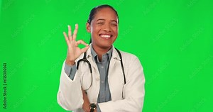 Okay emoji, face and doctor on green screen of healthcare success, support or excellence in services. Happy medical worker or latino woman for helping sign, good job or yes hands on studio background