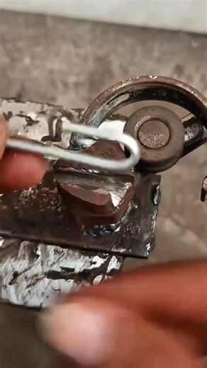 holding metal pin against custom welding tool and positioning mechanical components for assembly