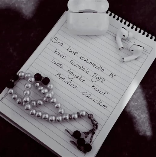 Handwritten Message in Non-English Script on Notebook