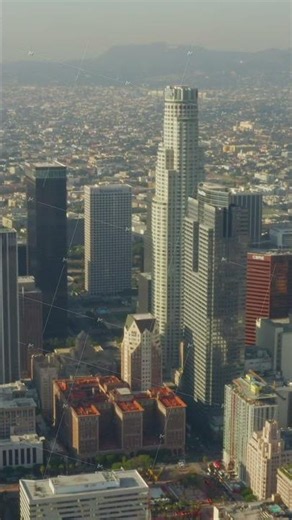 AERIAL: Breathtaking wide shot of Downtown Los Angeles, California Skyline in beautiful sunlight