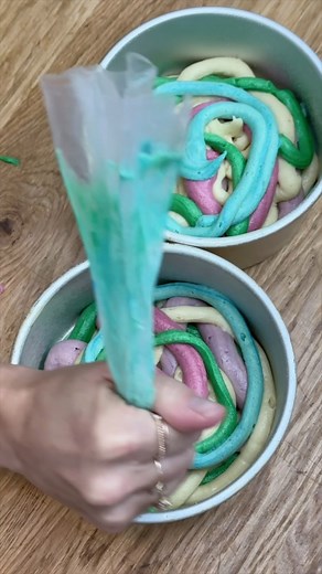 Emily | British Girl Bakes | Cake Decorating on Instagram: "Is it worth tinting your cake batter? 🎨 I think so! It’s fun to pipe squiggles of colourful batter and although the edges of the cakes will darken as they bake, when you cut into them you’ll see the bright colours inside. This is my Very Vanilla cake (recipe on my site) and I’m using @chefmaster gel colours. Follow @britishgirlbakes for more cake decorating ideas, tips, techniques and designs! #cake #cakes #buttercreamcakes #rainbowcak