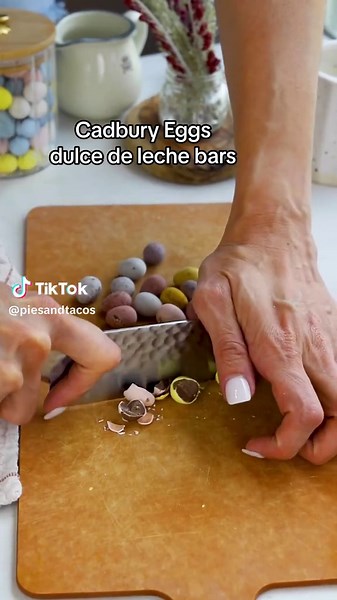 Recipe: -1 cup unsalted butter at room temperature (226 grams) -1/2 cup brown sugar (100 grams) -1 cup granulated sugar (200 grams) -2 eggs -1 teaspoon vanilla extract -2 1/2 cups all-purpose flour (318 grams) -1 teaspoon fine sea salt -1 teaspoon baking soda -1/4 teaspoon baking powder -1/2 cup white chocolate chips -1 cup chopped Cadbury Eggs -1 1/3 cup dulce de leche (396 grams) Line a 9x9” pan with parchment paper and grease it. Beat the butter for 1 minute, add the brown sugar and granulate