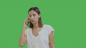 Woman talking on the phone with chroma background - Free Stock Video