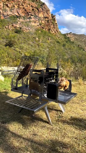 🔥 Imagine this: a braai so compact it fits in an ammo box — yet powerful enough to spin a rotisserie chicken, grill garlic bread, roast a staanrib, and sear a lamb rack… all at once. All while feeding a roaring, continuous fire. This isn’t just a braai box. It’s the KuruBox Pro — built for the wild, born for the flame. 🎥 @anthoard #dreemFIRE #KuruBoxPro #ThatBraaiGuy #BuiltForTheFlame #OverTheFireCooking | Dreem Fire