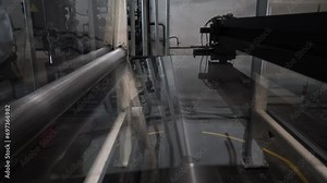 Chemical production of the bopp film. roll of plastic packaging film on the automatic packing machine in food product factory. industrial and technology concept.