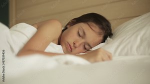 Adorable little girl sleeping in a bed. Close up