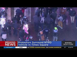 Protesters surround NYPD vehicle in Times Square