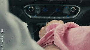 Woman starts to Hold her Boyfriends Hand while Driving in Modern Car